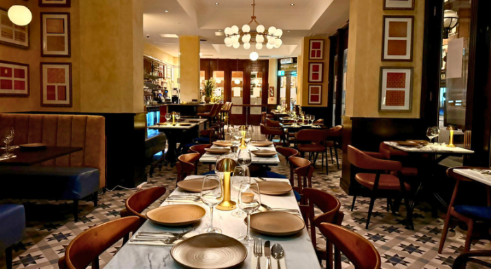Tiffin Tree's dining room with long tables, marble-topped surfaces and patterned floor tiling